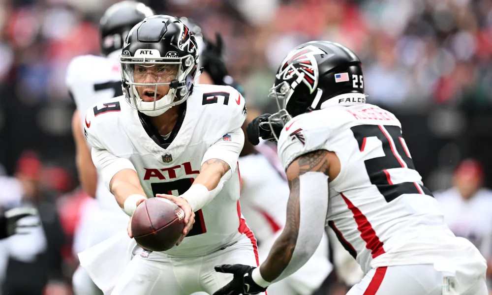 Desmond Ridder hands off to running back Tyler Allgeier against the Jacksonville Jaguars.